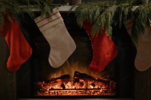 Photo of stockings hanging on a mantelpiece over a fire